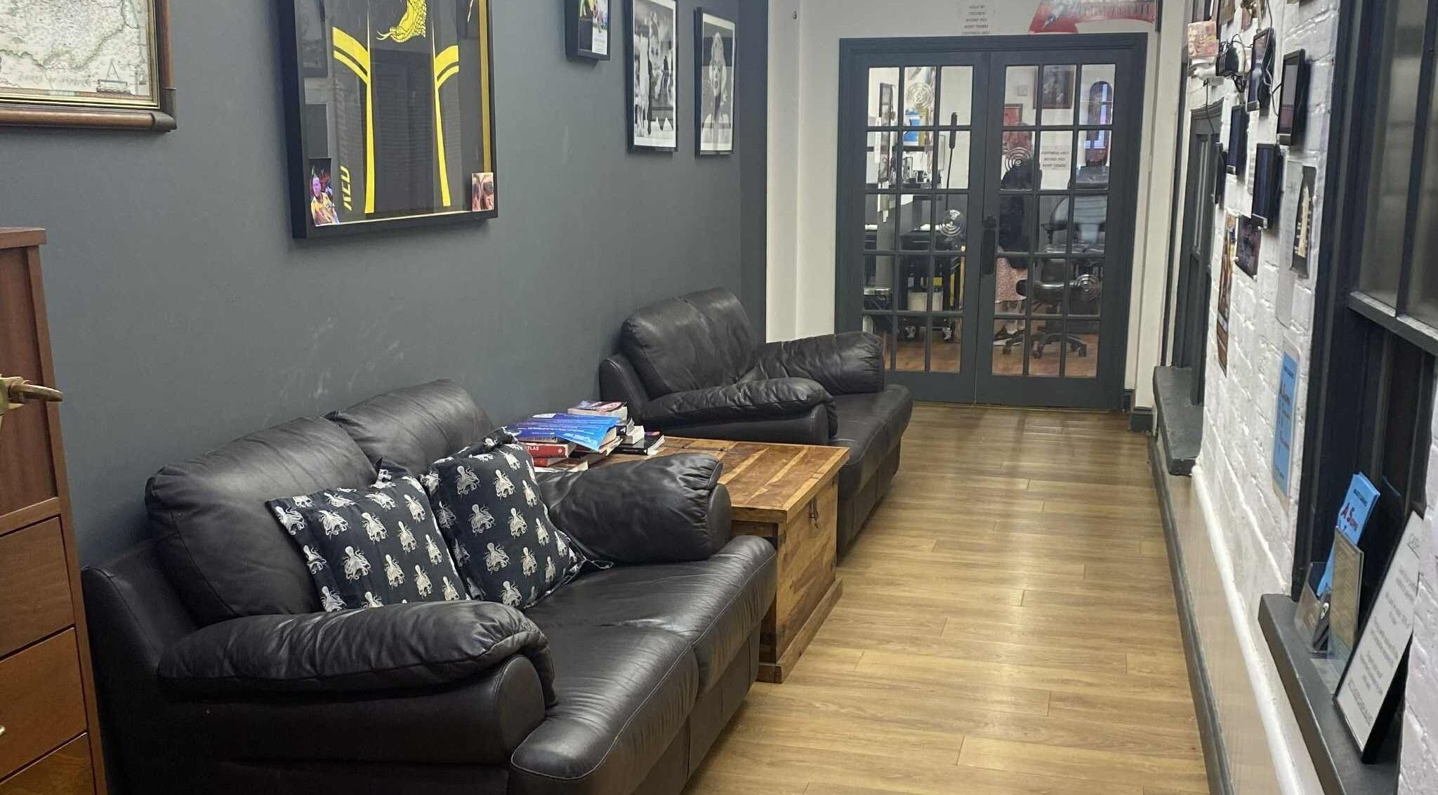 Comfortable leather seating area at Kracken Body Art, Gorleston-on-Sea, England, GB.