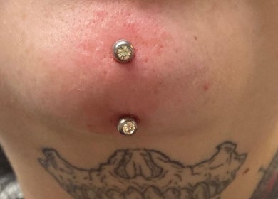 Chin piercings with gemstones at Kracken Body Art, Gorleston-on-Sea, England, GB showcasing elegance.