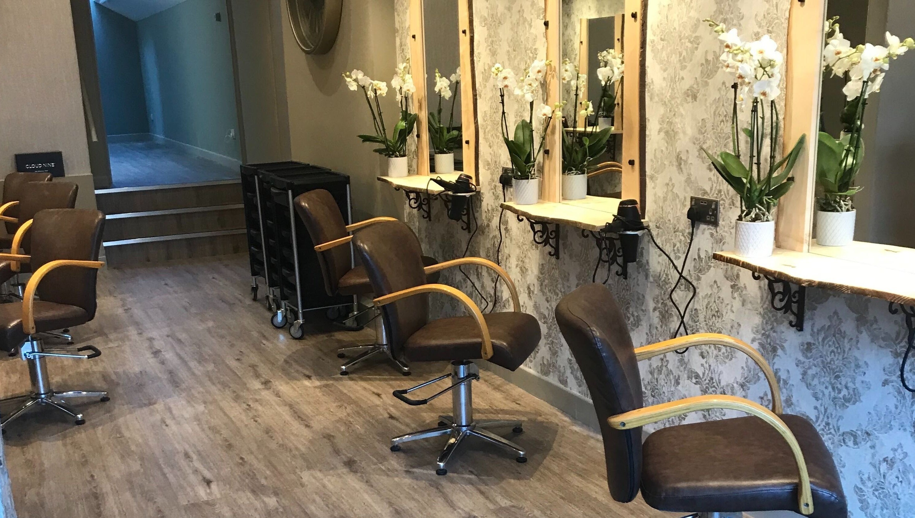 Carly and Co Hairdressing in Morecambe, England, GB, featuring chic chairs and elegant mirrors.