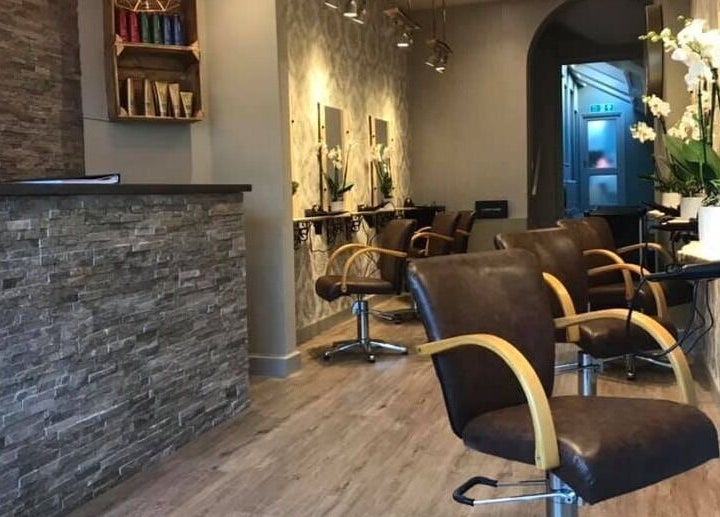 Modern interior of Carly and Co Hairdressing in Morecambe, England, GB with stylish chairs and a stone counter.