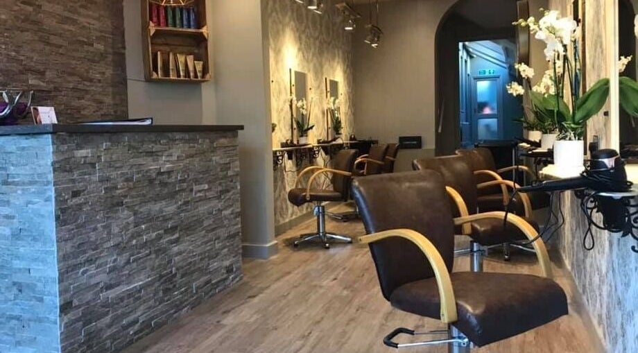 Modern interior of Carly and Co Hairdressing in Morecambe, England, GB with stylish chairs and a stone counter.