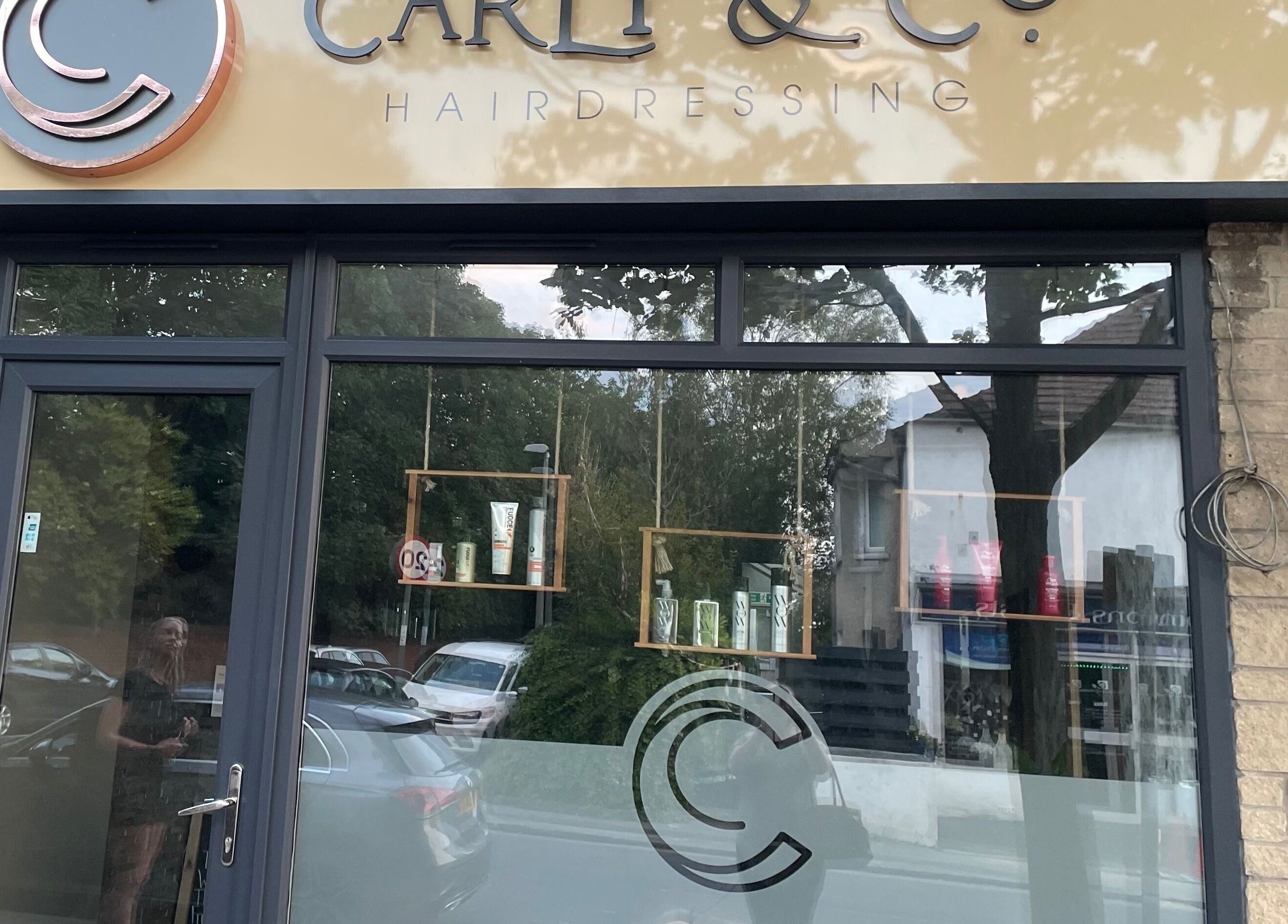 Shopfront of Carly and Co Hairdressing in Morecambe, England, GB, showcasing its elegant signage and glass windows.