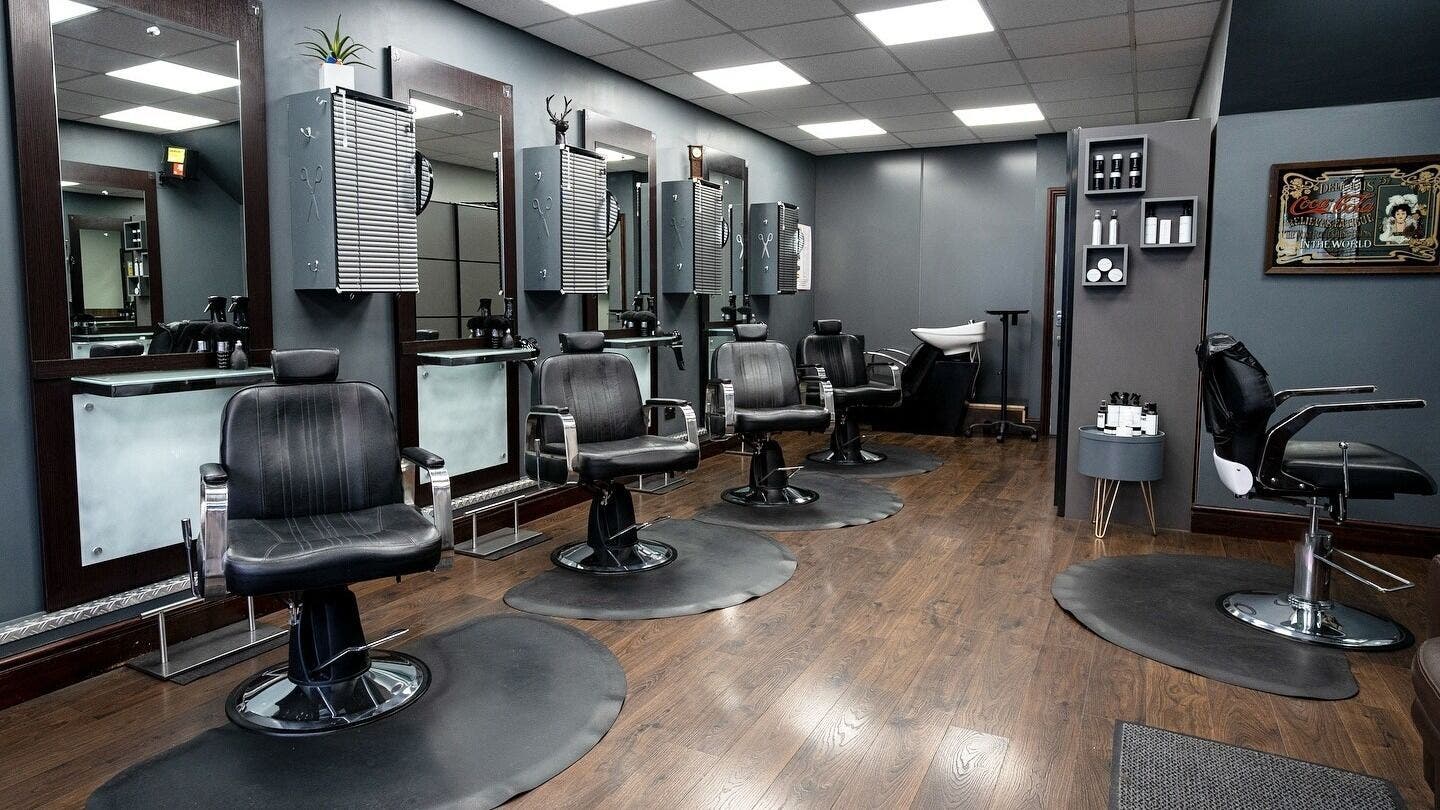 Modern barber chairs at Cuts ‘N’ Clippers Barbers Haircuts, located in Horley, England, GB.