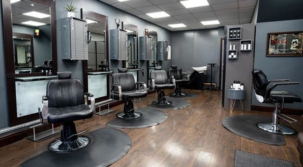 Cuts ‘N’ Clippers Refinery Rooms hair salon interior in Horley, England, GB, showcasing elegant barber chairs.