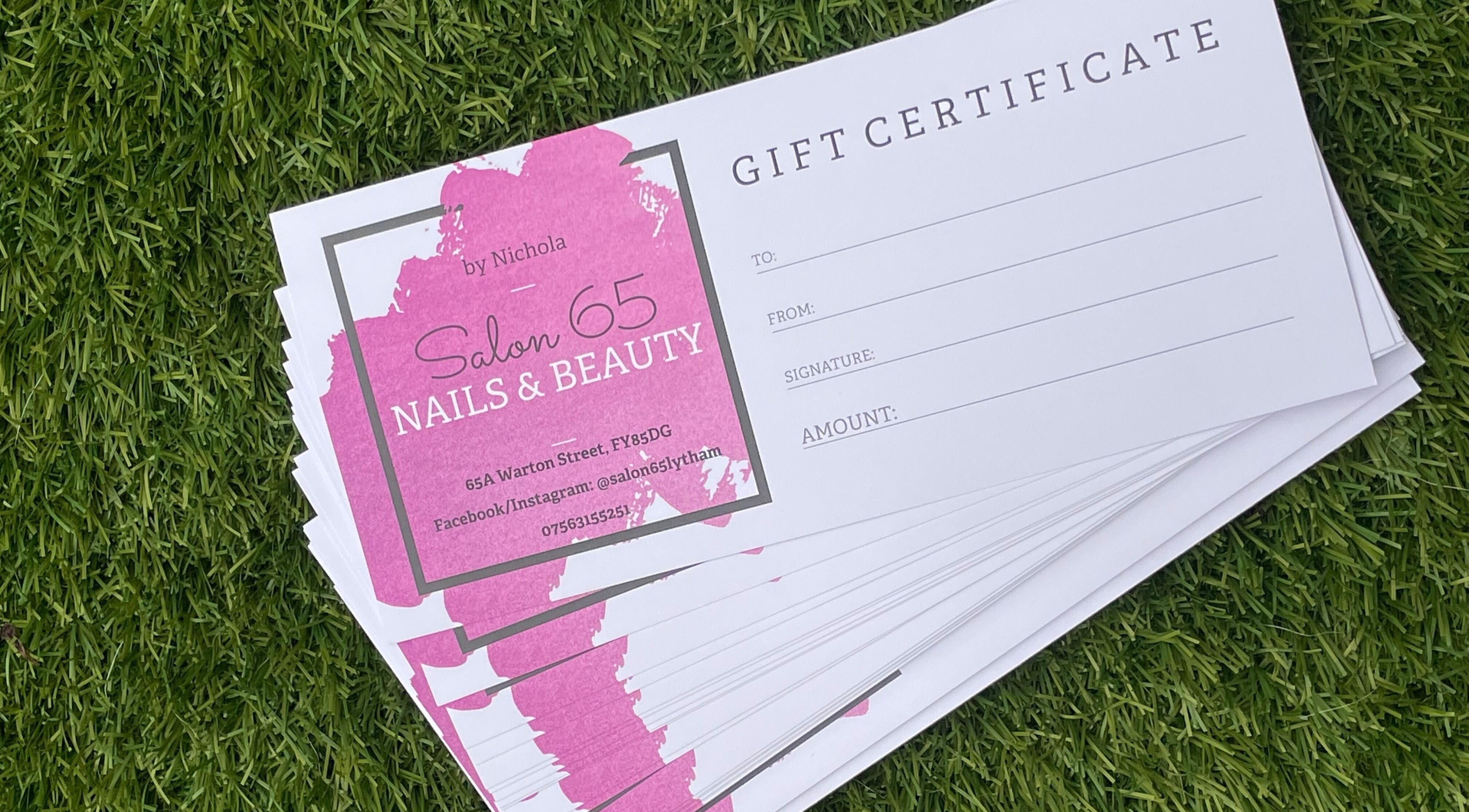 Gift certificate stack from Salon 65 Lytham on grass, Lytham Saint Annes, England, GB.