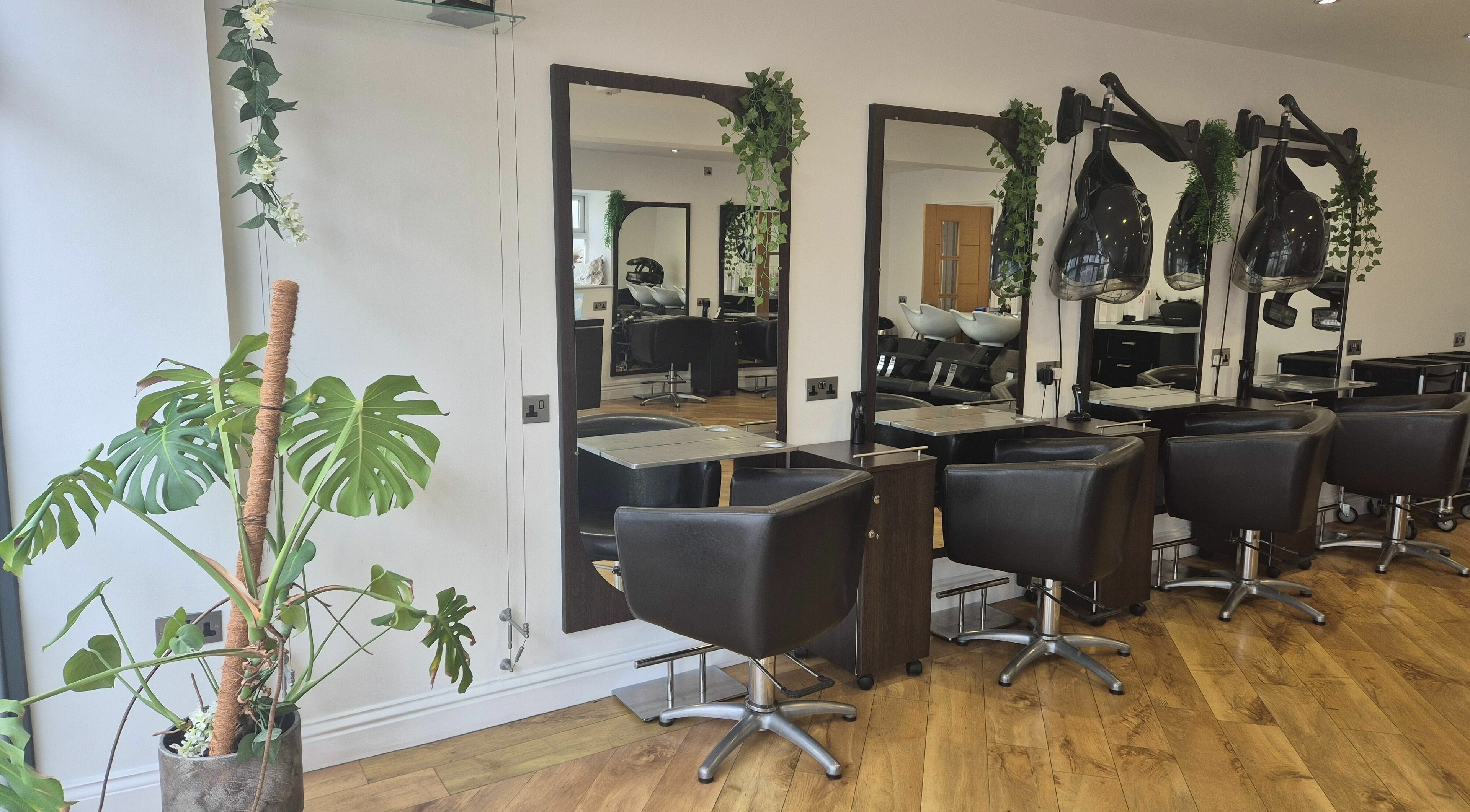 Modern salon setup at Temptations Hair And Beauty in Jersey, JE with chic chairs and mirrors.