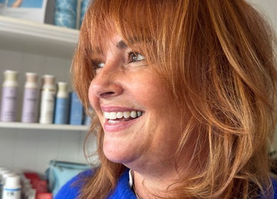 Smiling woman with vibrant hairstyle at Luxe Hair Lab, Kyneton, Victoria, AU.