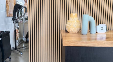 Stylish decor at Luxe Hair Lab reception in Kyneton, Victoria, AU, featuring artful vases and modern design.