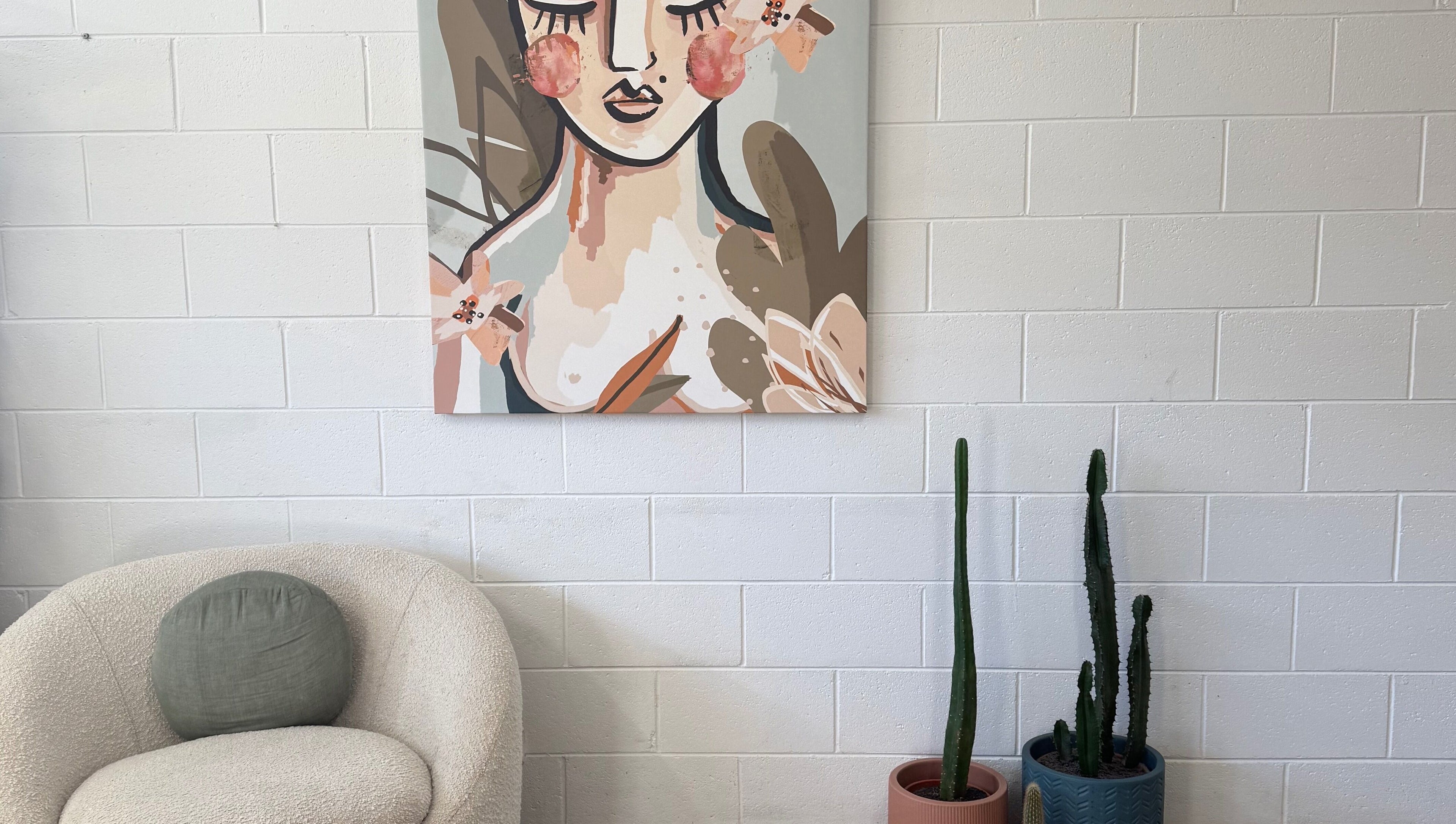 Cozy corner at Luxe Hair Lab, Kyneton, Victoria, AU with abstract art and cacti adding flair.