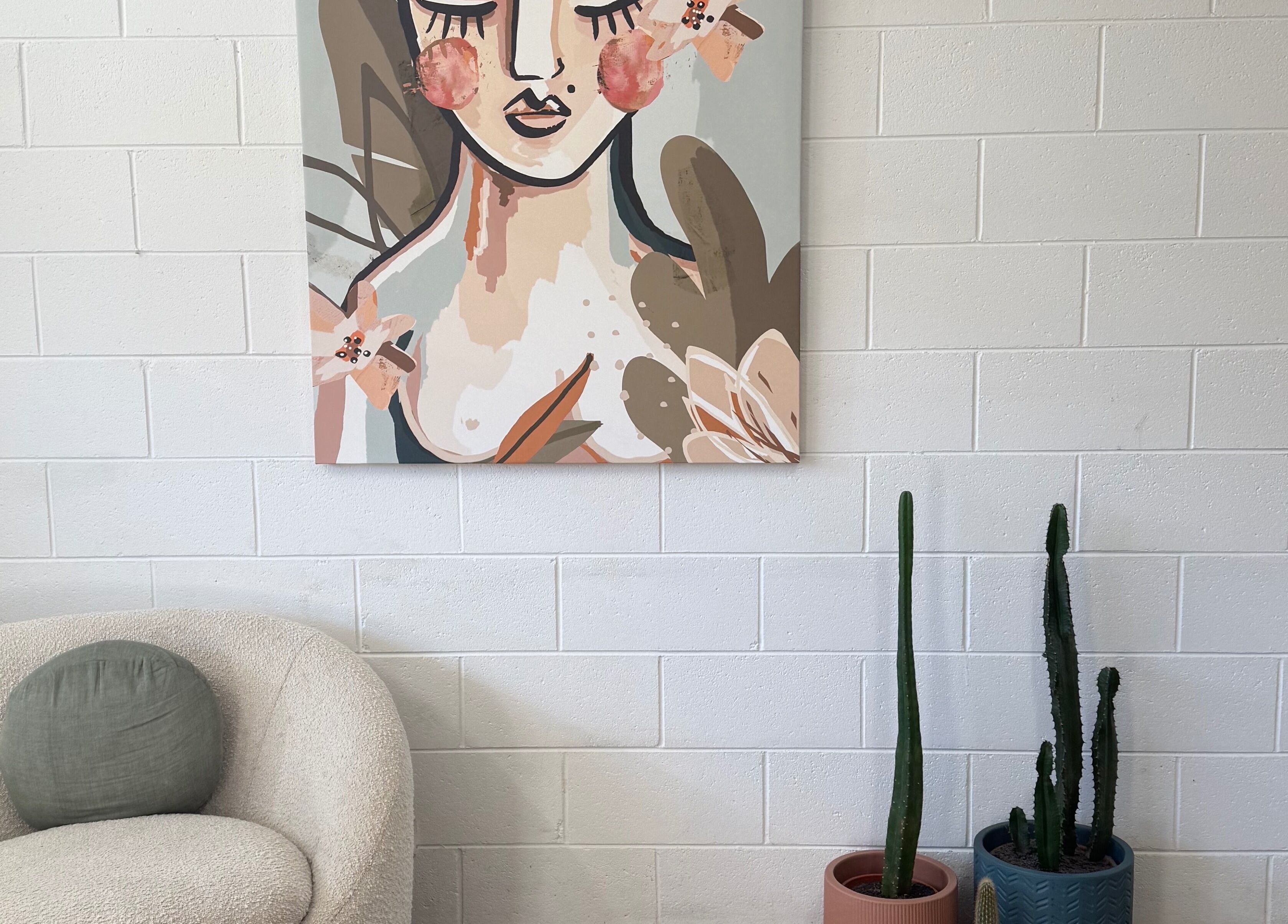 Cozy corner at Luxe Hair Lab, Kyneton, Victoria, AU with abstract art and cacti adding flair.