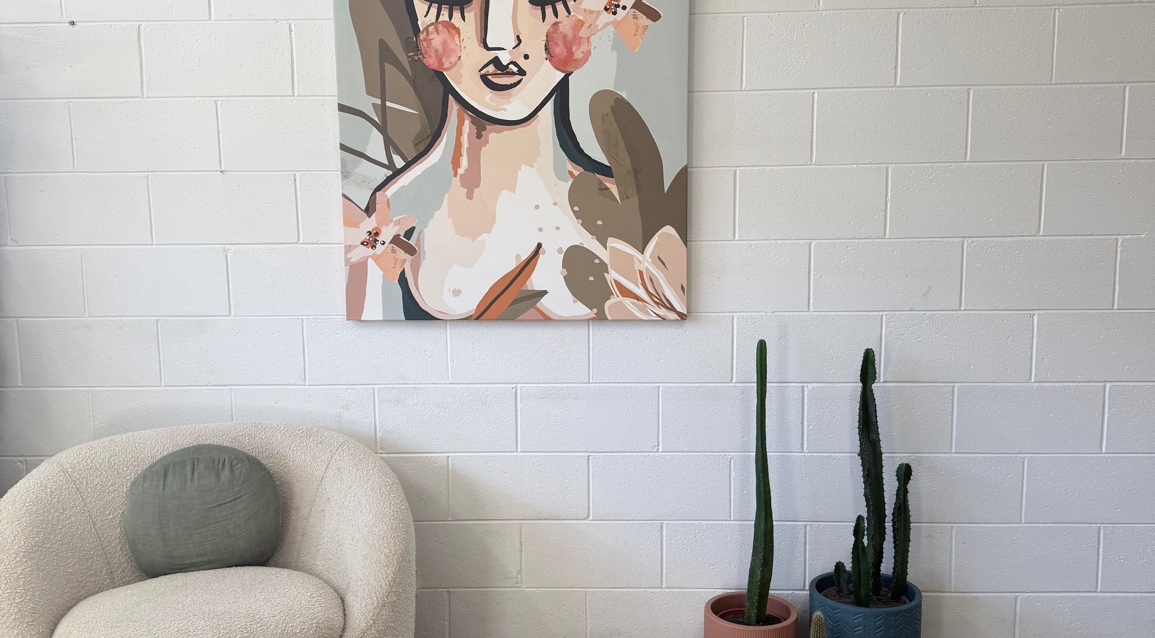 Cozy corner at Luxe Hair Lab, Kyneton, Victoria, AU with abstract art and cacti adding flair.