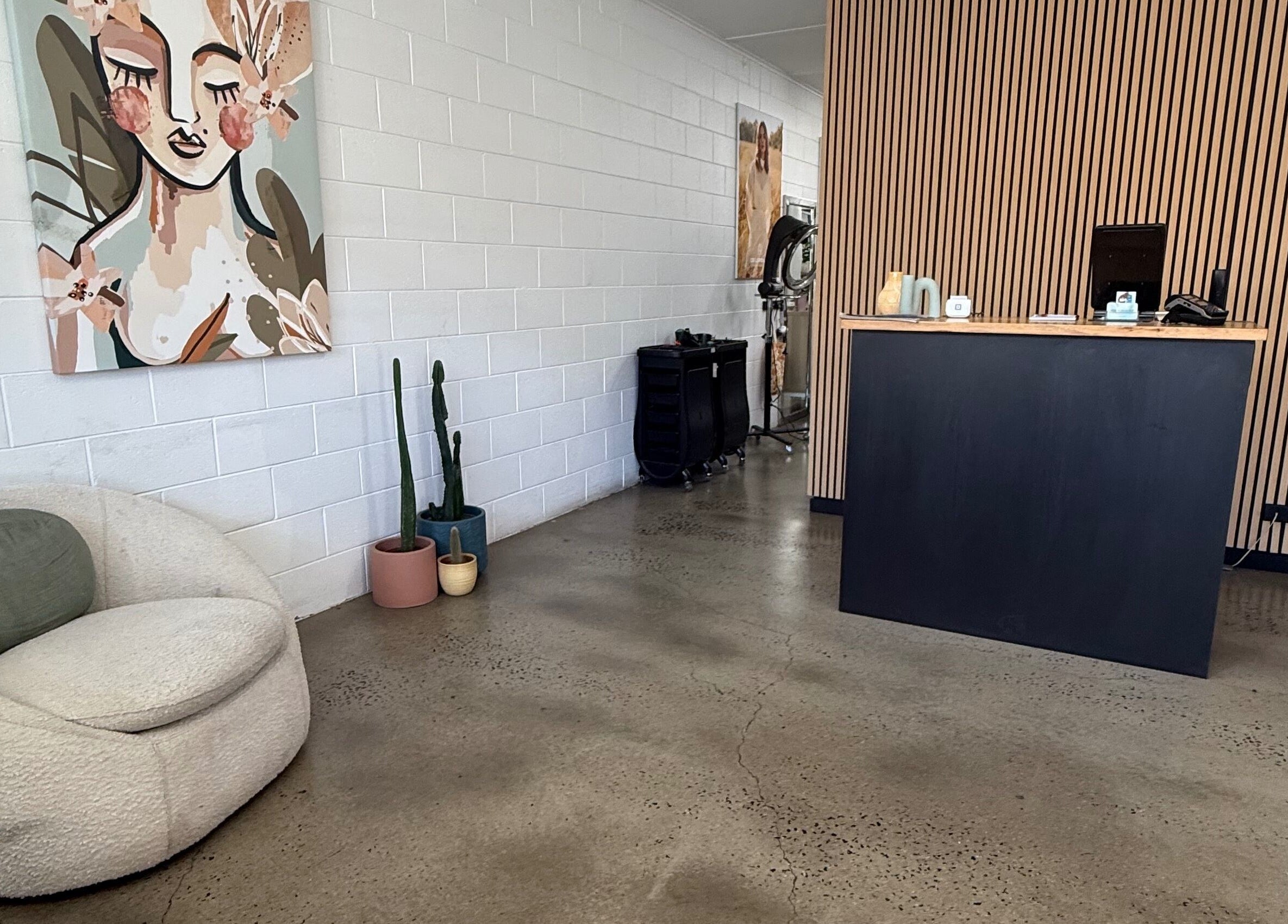 Elegant reception at Luxe Hair Lab, Kyneton, Victoria, AU with art and cozy seating.