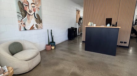 Elegant reception at Luxe Hair Lab, Kyneton, Victoria, AU with art and cozy seating.