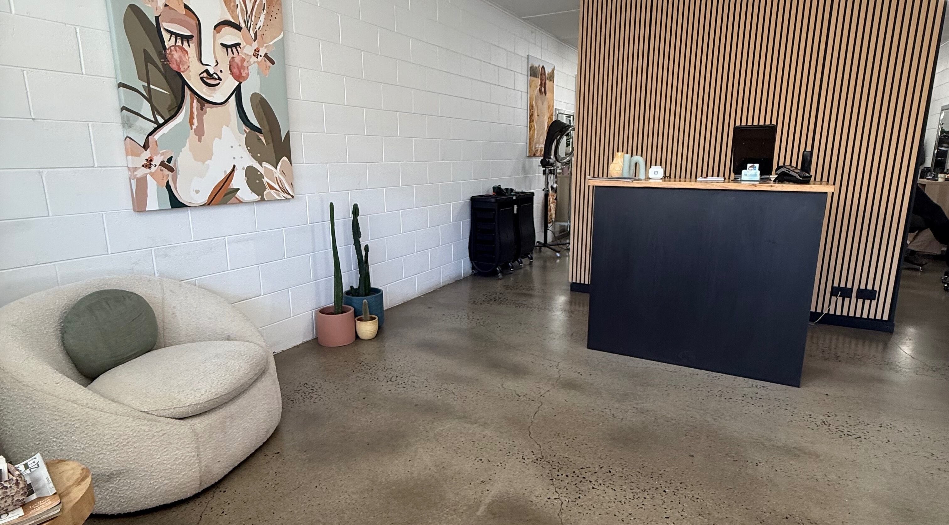 Elegant reception at Luxe Hair Lab, Kyneton, Victoria, AU with art and cozy seating.