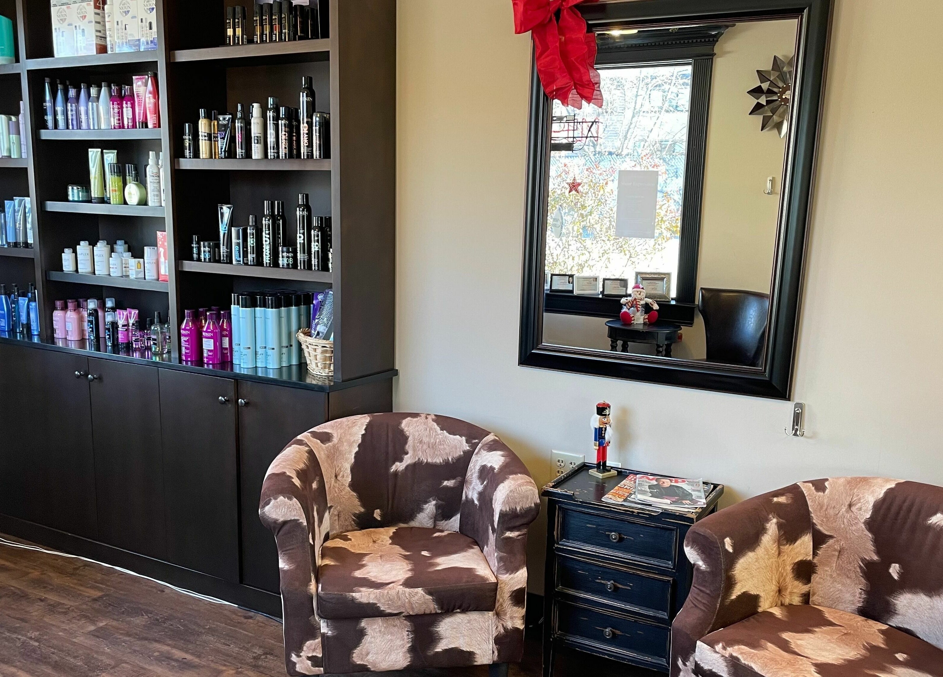 Chic seating area at Shear Expression, Newton, New Jersey, US with shelves of beauty products.