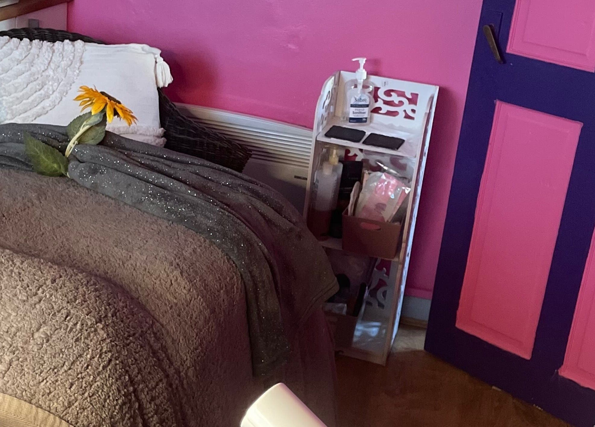 Comfortable treatment room at A Little Unorthodox, Allesley Coventry, England, GB with pink walls and sunflowers.