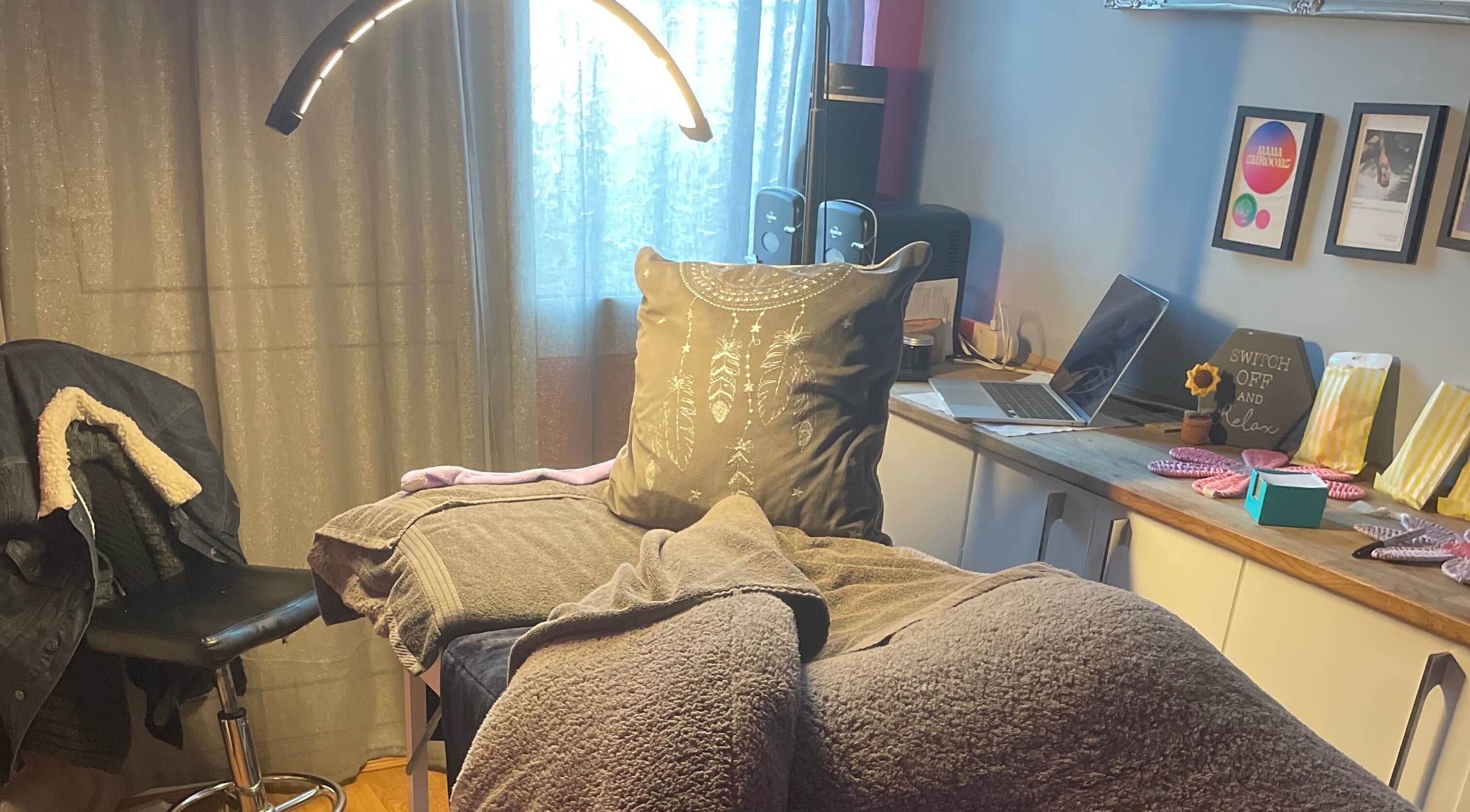 Relaxing treatment room at A Little Unorthodox, Allesley Coventry, England, GB, with soft lighting and cozy decor.