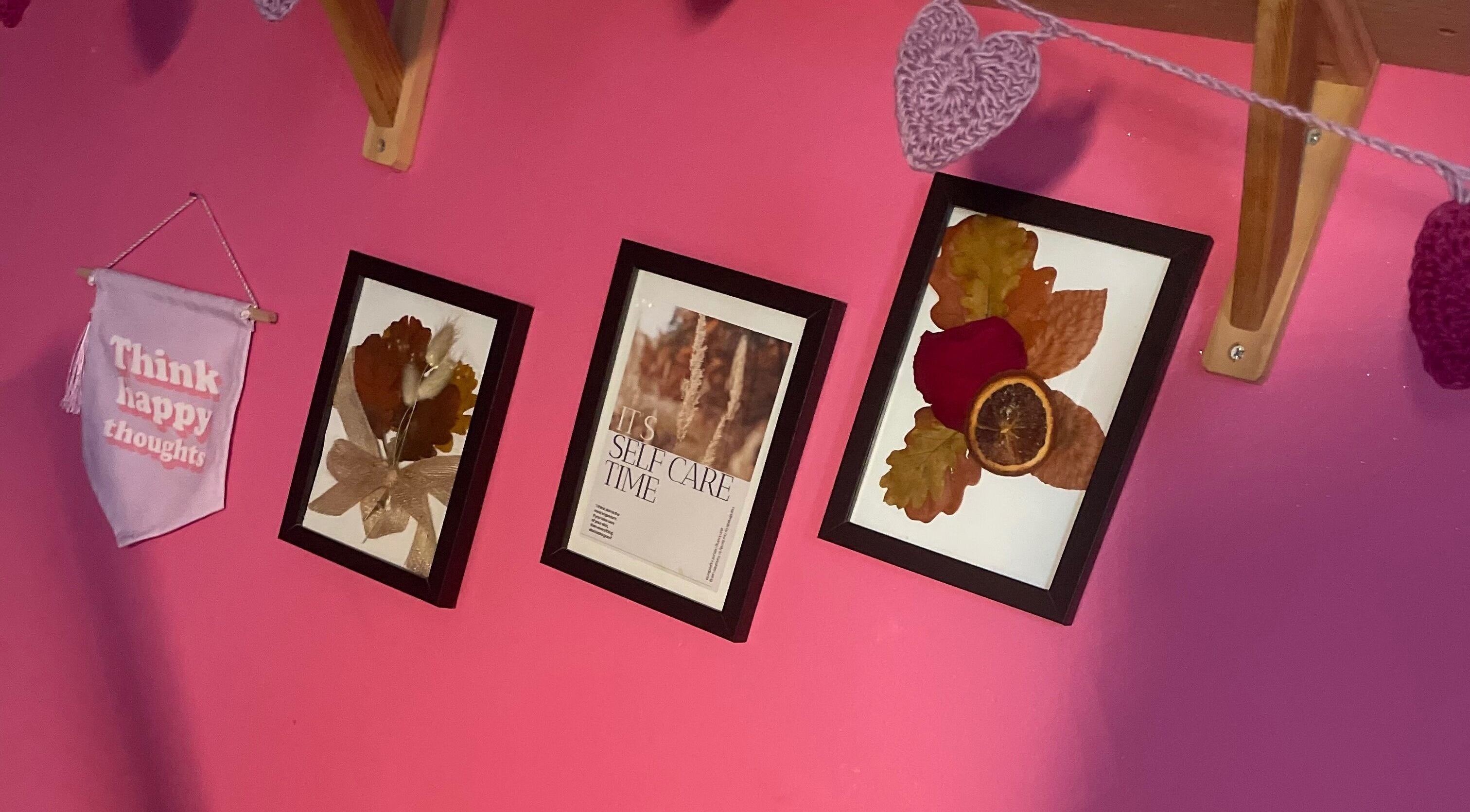 Artistic wall with frames and banner at A Little Unorthodox, Allesley Coventry, England, GB.