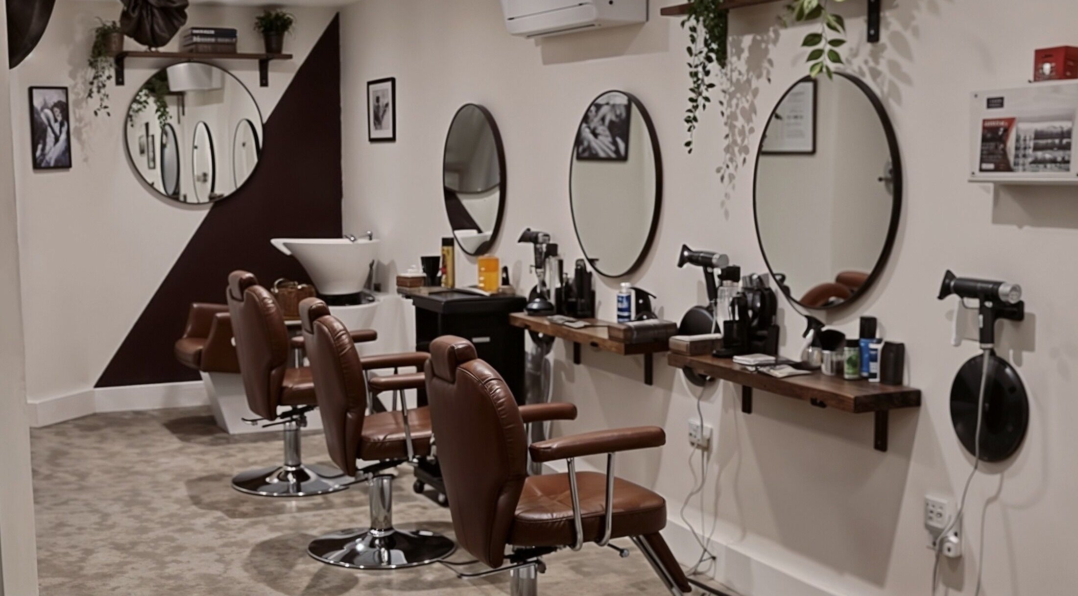 Interior view of Copper Row Barbers in London, England, GB showcasing modern barber chairs and mirrors.