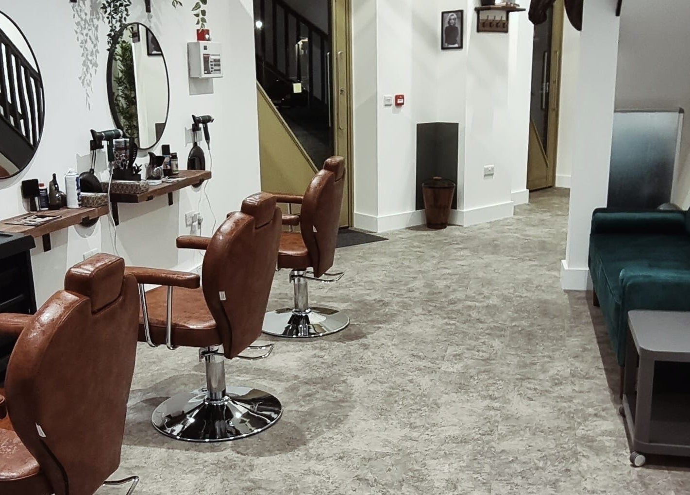 Interior of Copper Row Barbers, stylish leather chairs and mirrors, located in London, England, GB.