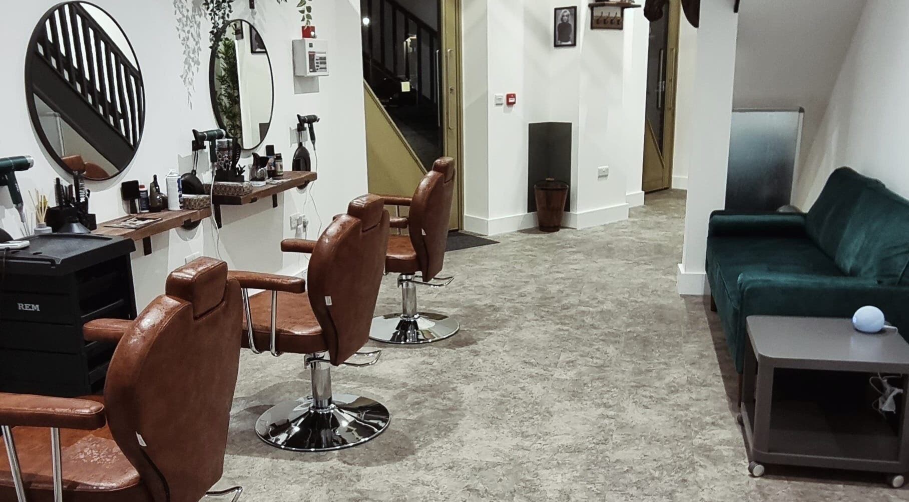 Interior of Copper Row Barbers, stylish leather chairs and mirrors, located in London, England, GB.