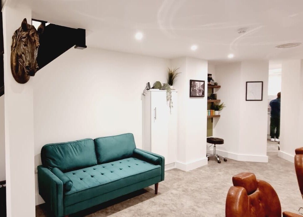 Stylish interior of Copper Row Barbers in London, England, GB featuring modern seating and decor.