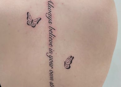 Back tattoo with script and butterflies at Fineline Tattoos By Carla, Melbourne, Victoria, AU.