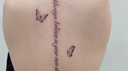 Back tattoo with script and butterflies at Fineline Tattoos By Carla, Melbourne, Victoria, AU.
