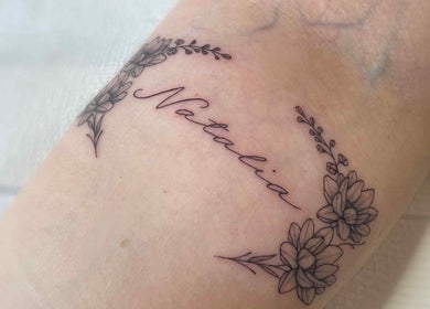 Delicate floral name tattoo by Fineline Tattoos By Carla, Melbourne, Victoria, AU.