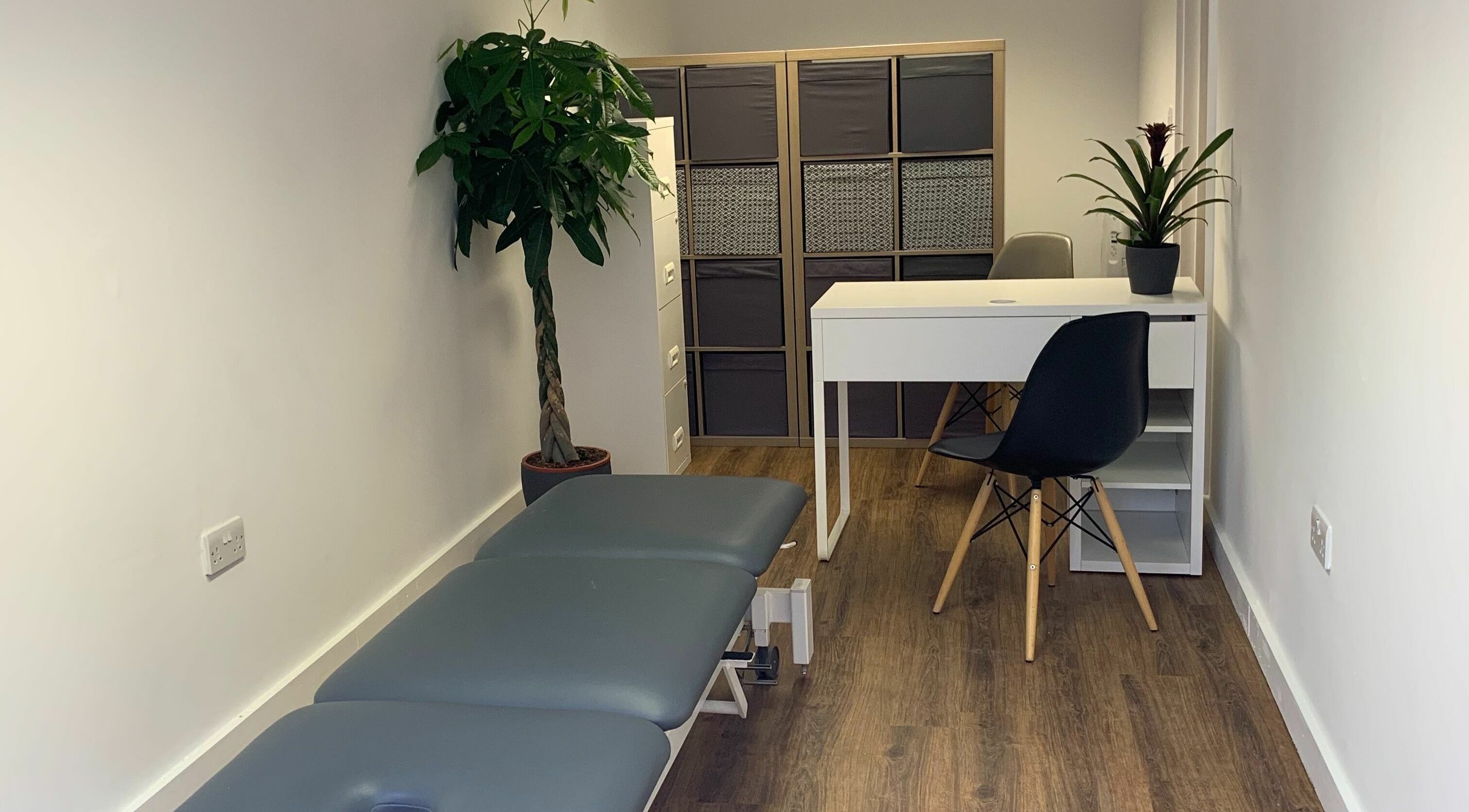 Calm treatment room at The Lancaster Osteopathic Clinic, Ware, England, GB with a massage table and minimalist decor.
