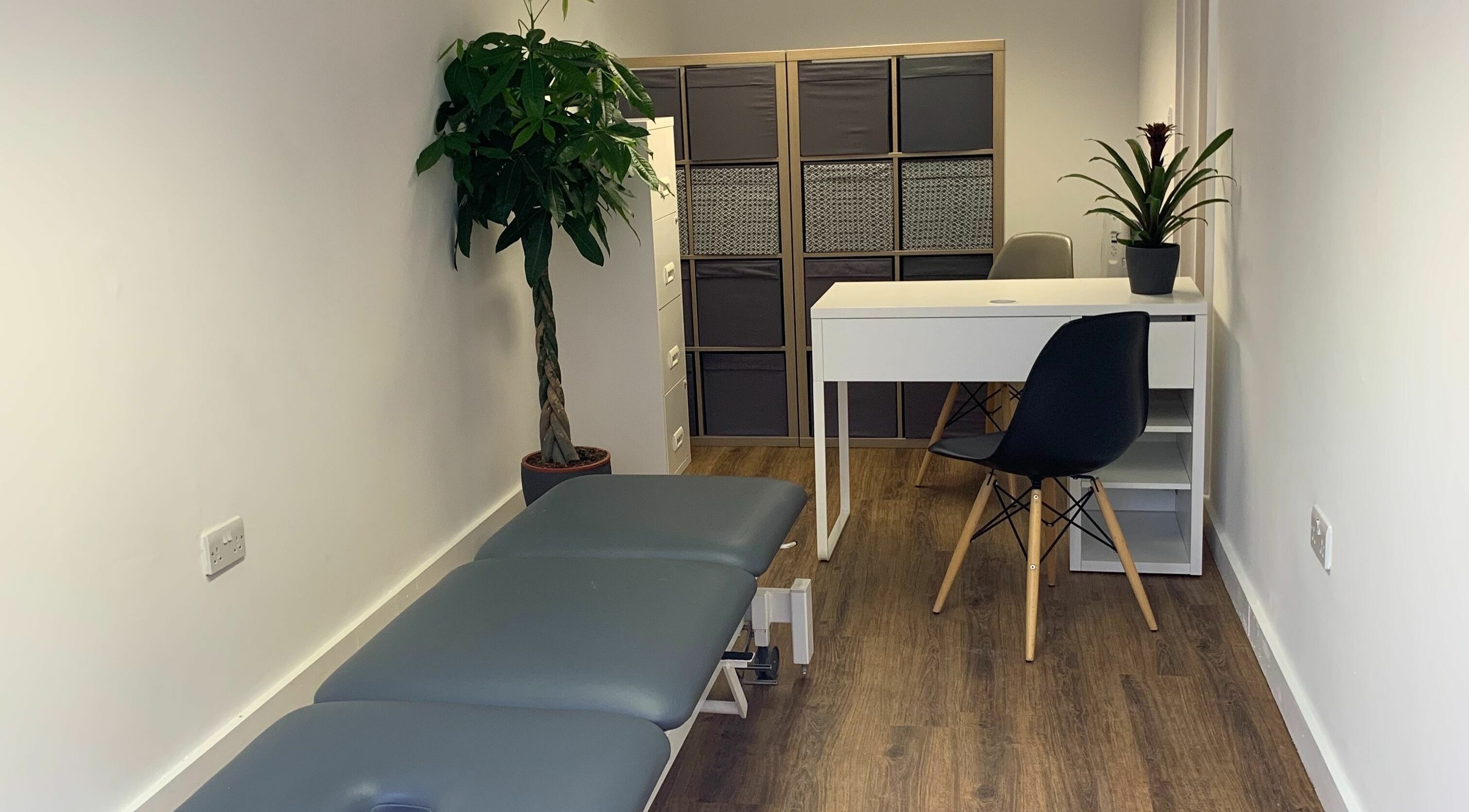 Calm treatment room at The Lancaster Osteopathic Clinic, Ware, England, GB with a massage table and minimalist decor.