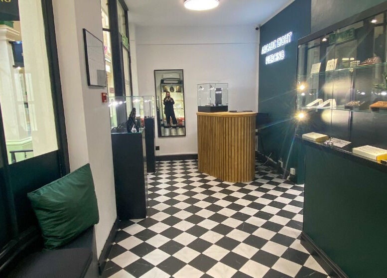 Stylish interior of Arcade Eight Piercing at Newport Pagnell, England, GB, showcasing elegant design and ambiance.