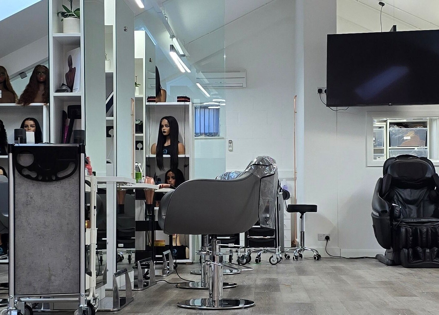 Modern salon interior at Happy Hair - UK, Abbots Langley, England, featuring styling chairs and mirrors.