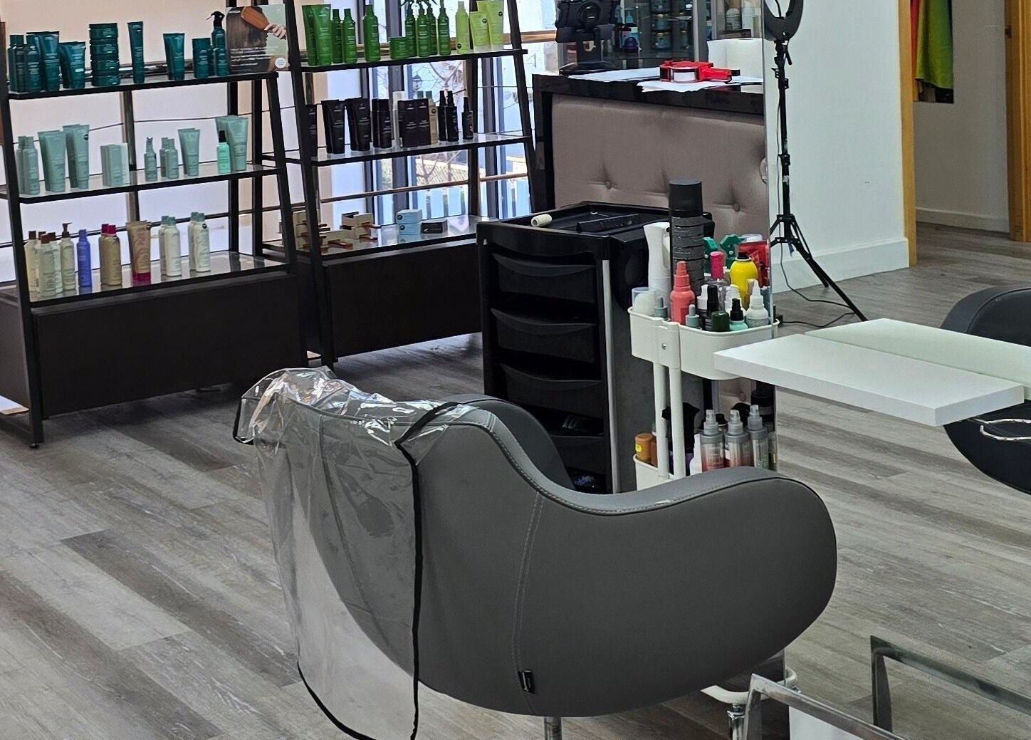 Modern salon interior at Happy Hair - UK, Abbots Langley, England with stylish furniture and products on display.