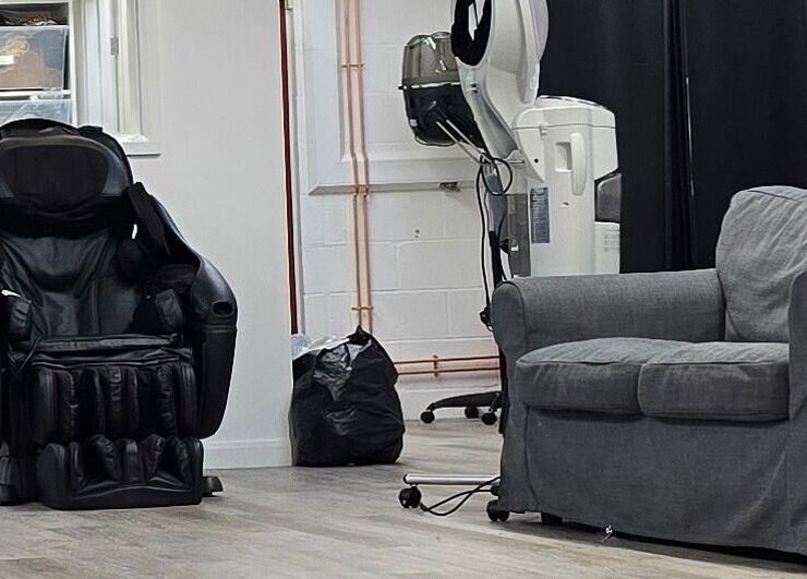 Comfortable seating at Happy Hair - UK, Abbots Langley, England, GB, featuring a massage chair and sofa.