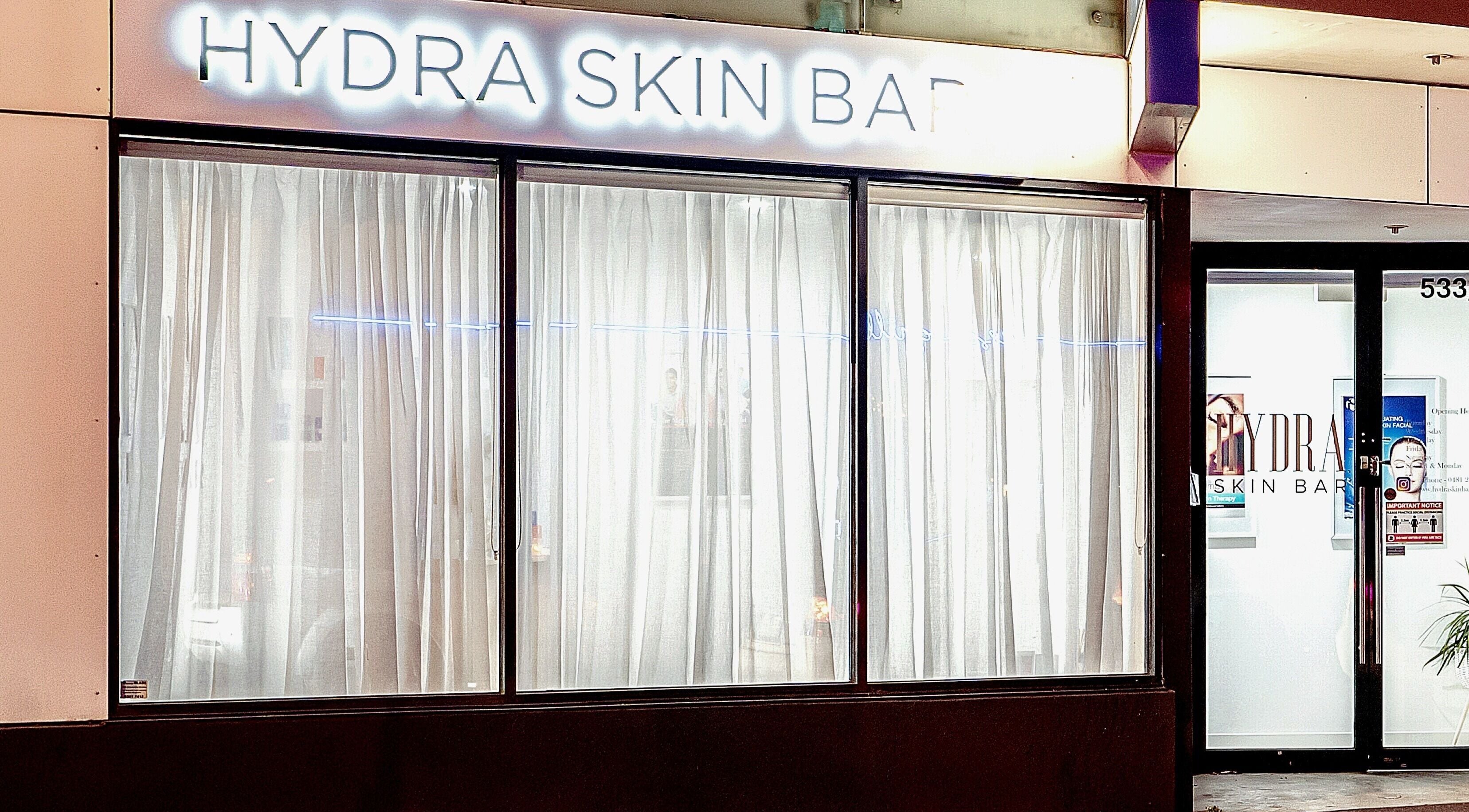 Front view of Hydra Skin Bar, Melbourne, Victoria, AU showcasing elegant windows and inviting entrance.