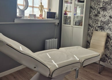 Modern treatment room at Evesham Aesthetics Clinic Limited, Evesham, England, GB with comfortable bed and decor.