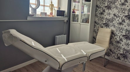 Modern treatment room at Evesham Aesthetics Clinic Limited, Evesham, England, GB with comfortable bed and decor.