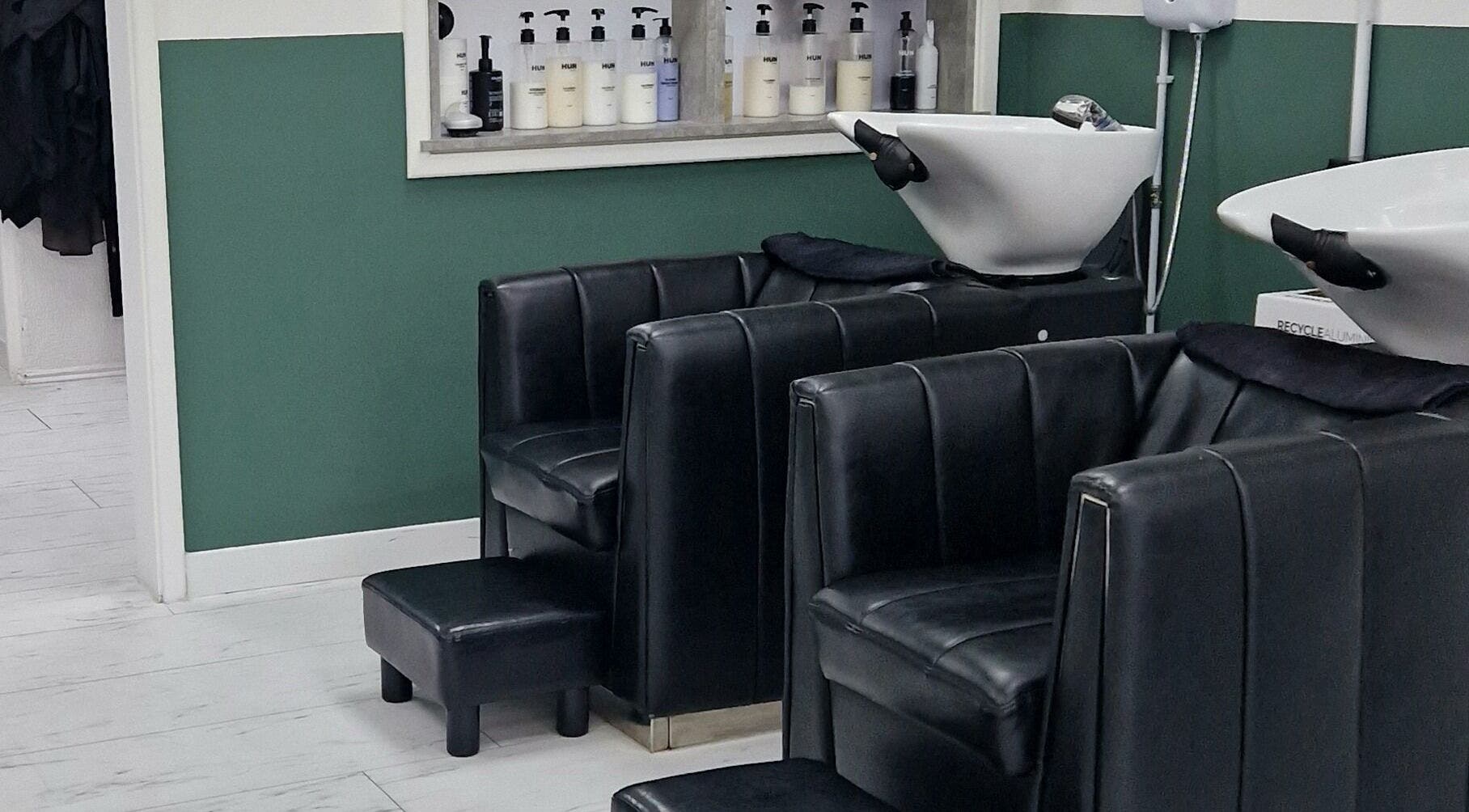 Chic wash stations at Hun Hair Bar in Upminster, England, GB, showcasing modern salon design.