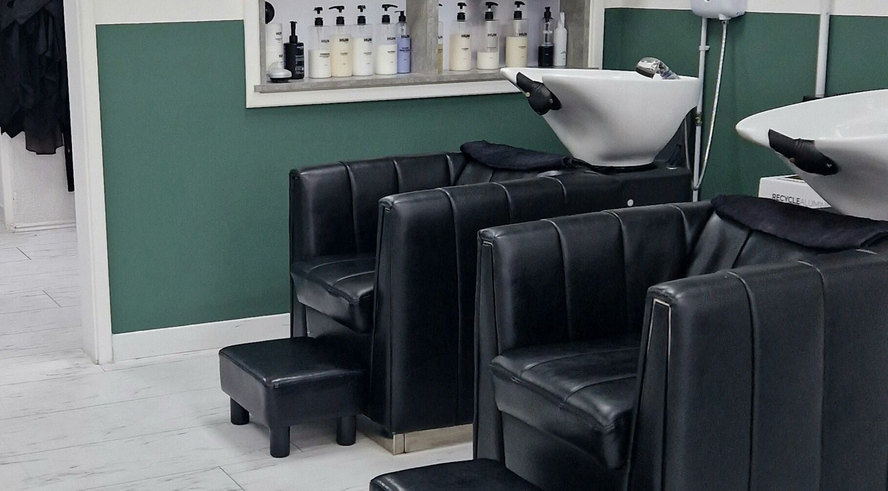 Chic wash stations at Hun Hair Bar in Upminster, England, GB, showcasing modern salon design.