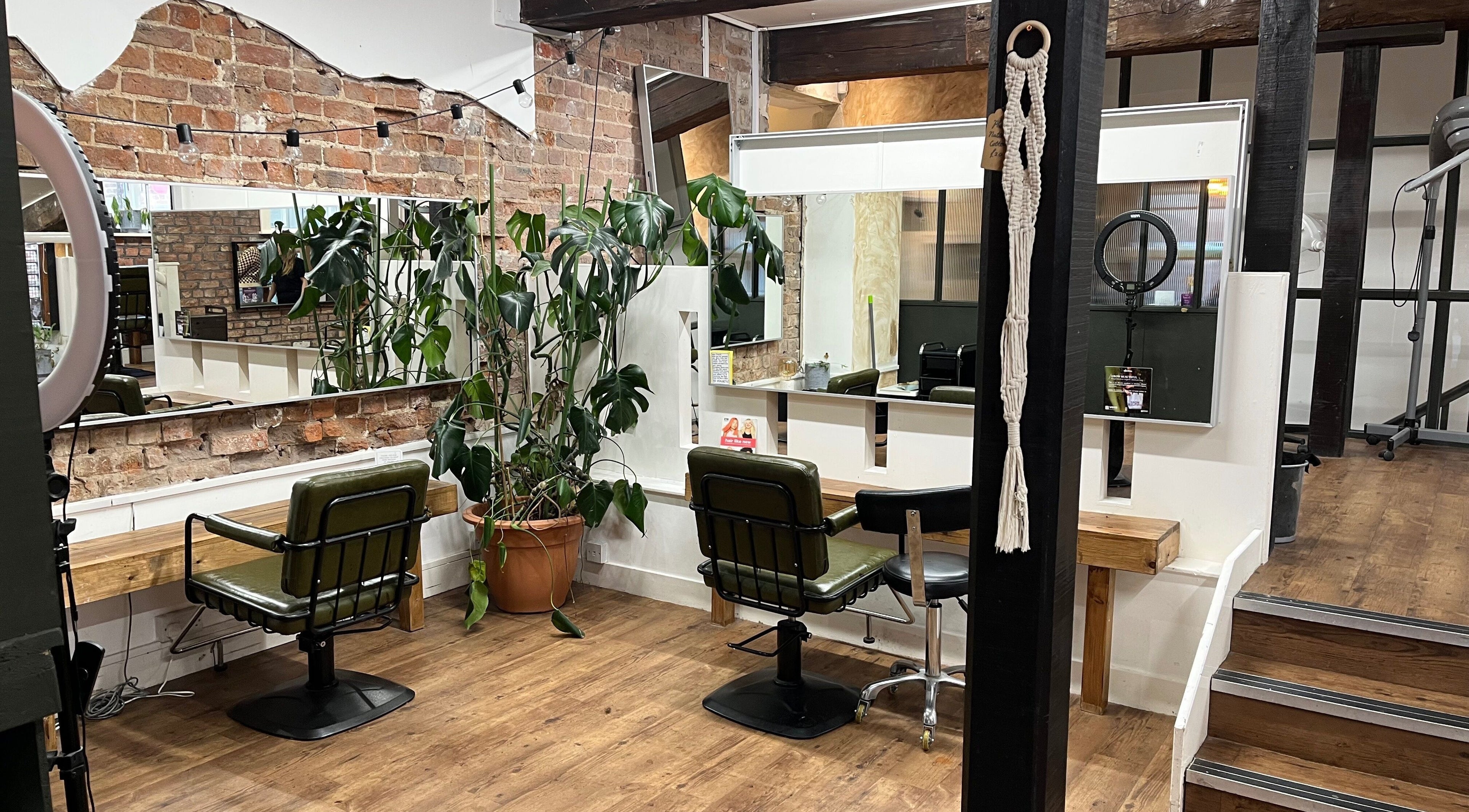 Modern salon interior at Henry Street Collective in Liverpool, England, GB showcasing chairs and mirrors.