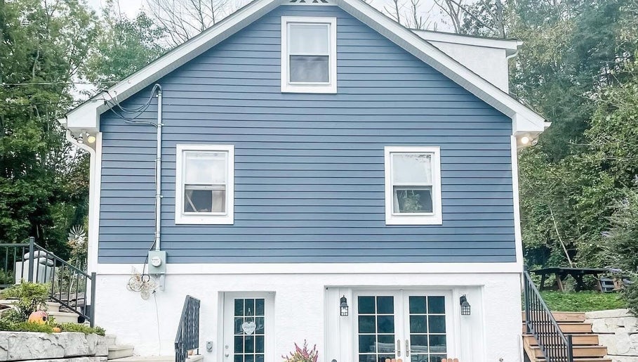 Charming exterior of Taboo Salon in Telford, Pennsylvania, US, featuring a stylish blue facade and welcoming stairs.