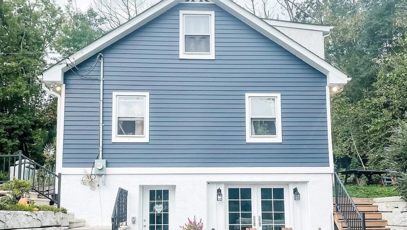 Charming exterior of Taboo Salon in Telford, Pennsylvania, US, featuring a stylish blue facade and welcoming stairs.