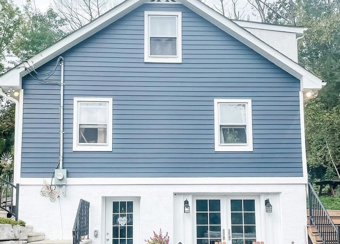 Charming exterior of Taboo Salon in Telford, Pennsylvania, US, featuring a stylish blue facade and welcoming stairs.