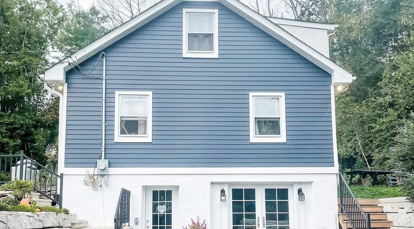 Charming exterior of Taboo Salon in Telford, Pennsylvania, US, featuring a stylish blue facade and welcoming stairs.