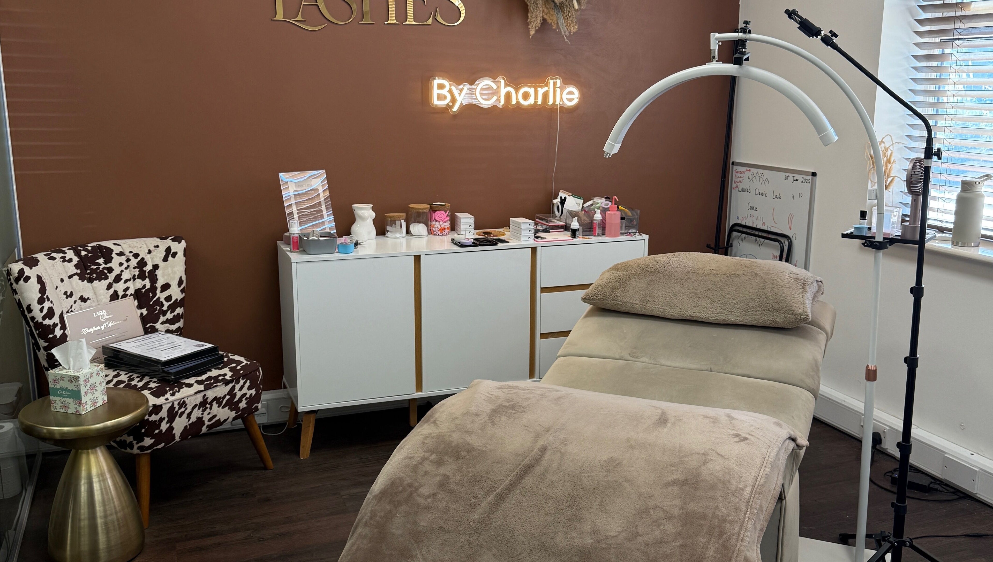 Elegant salon interior at Lashes by Charlie in Peterborough, England, GB with a stylish treatment bed and decor.