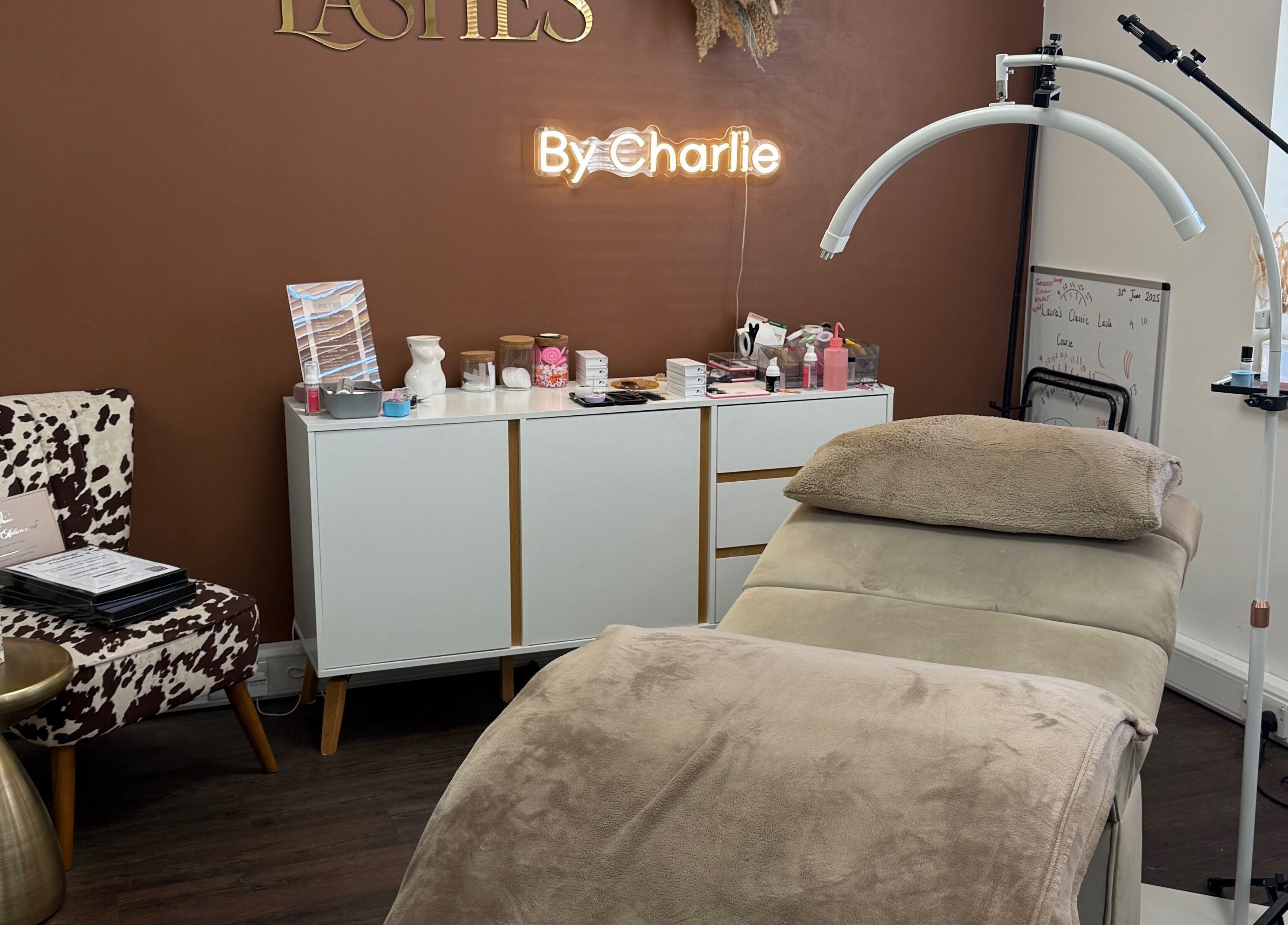 Elegant salon interior at Lashes by Charlie in Peterborough, England, GB with a stylish treatment bed and decor.