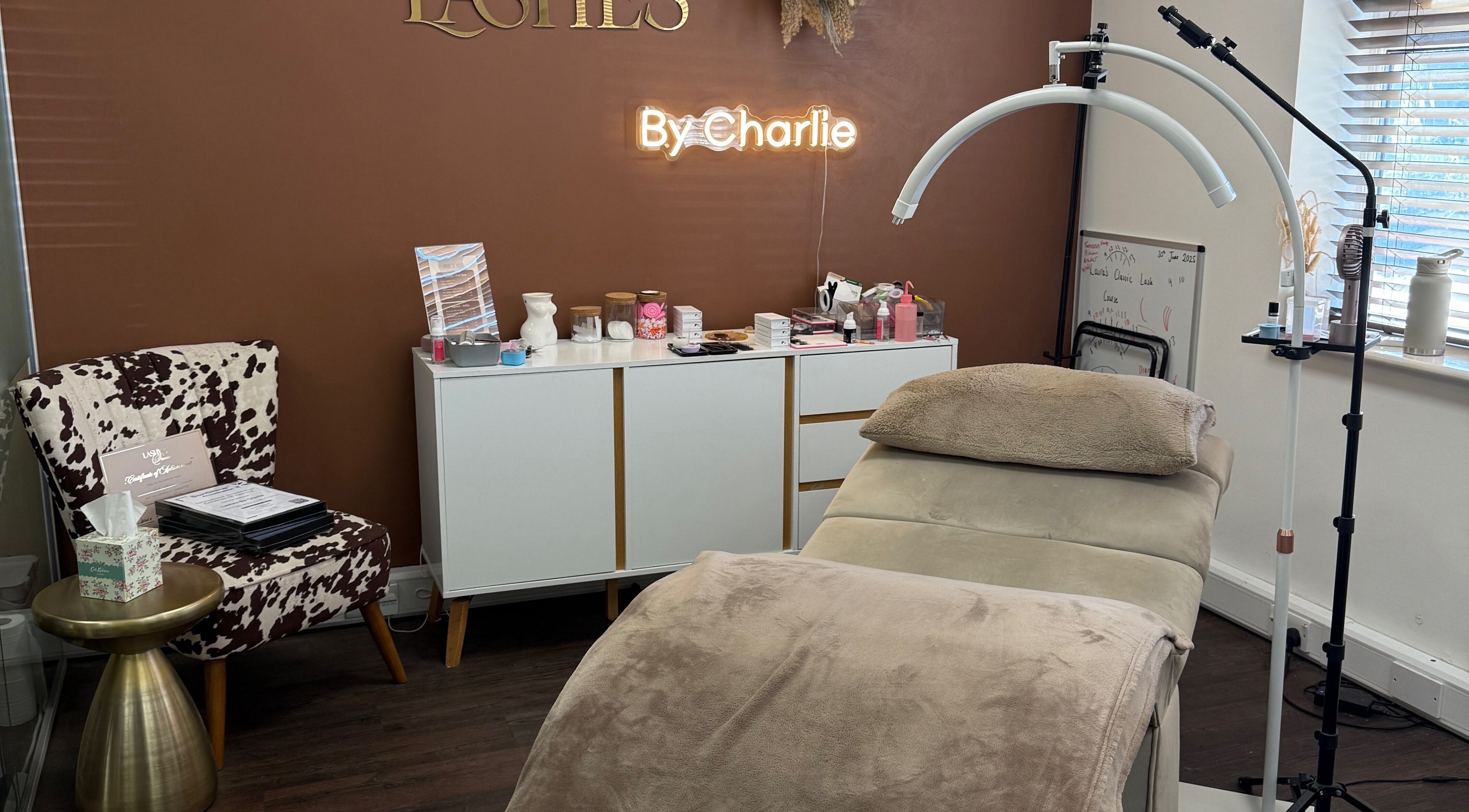 Elegant salon interior at Lashes by Charlie in Peterborough, England, GB with a stylish treatment bed and decor.