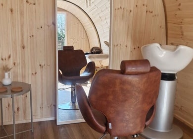 Karistyle salon interior with wooden decor and styling chair in Maidstone, England, GB.