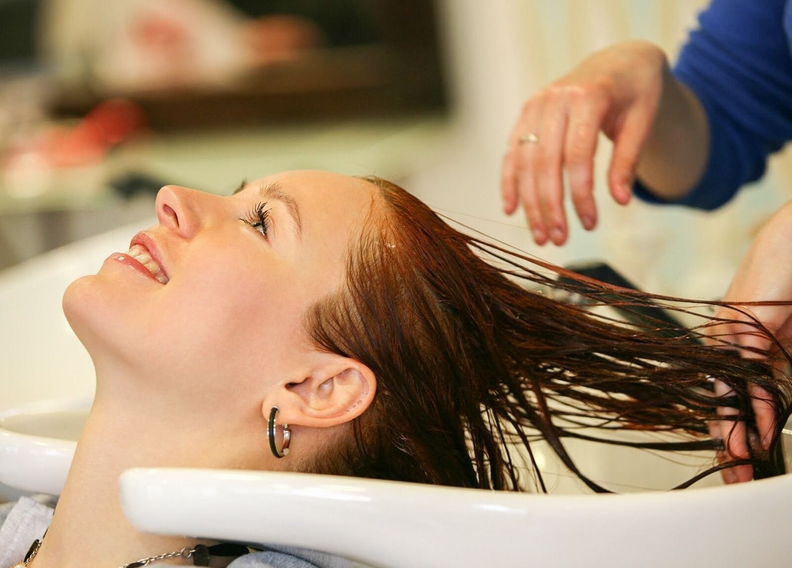 Client receiving hair wash at Joseph's Coiffures, Ottawa, Ontario, CA, enjoying a relaxing experience.